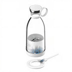 Clear glass bottle with metal lid and interior components on a white background