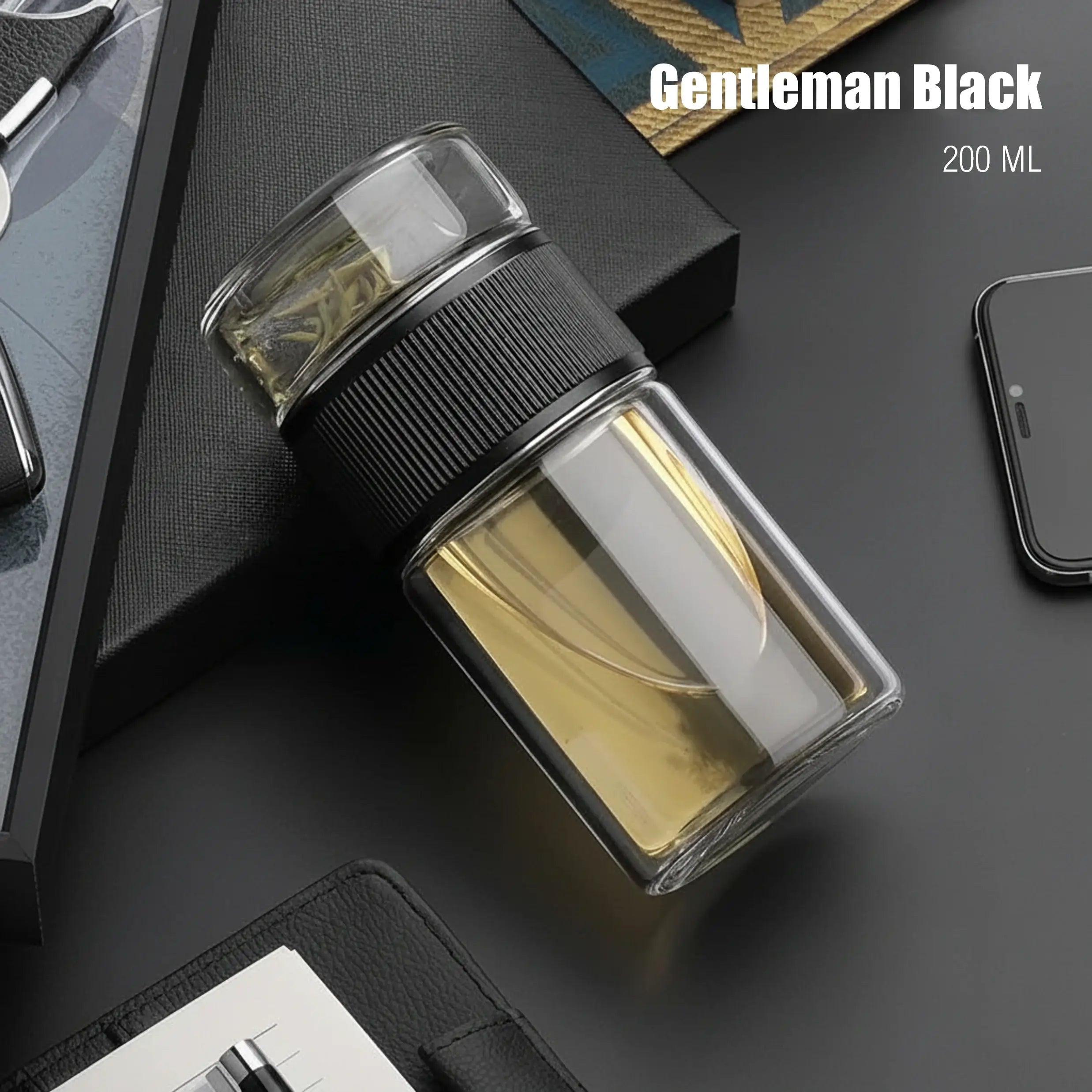 Glass bottle with black cap labeled 'Gentleman Black' on a dark surface.