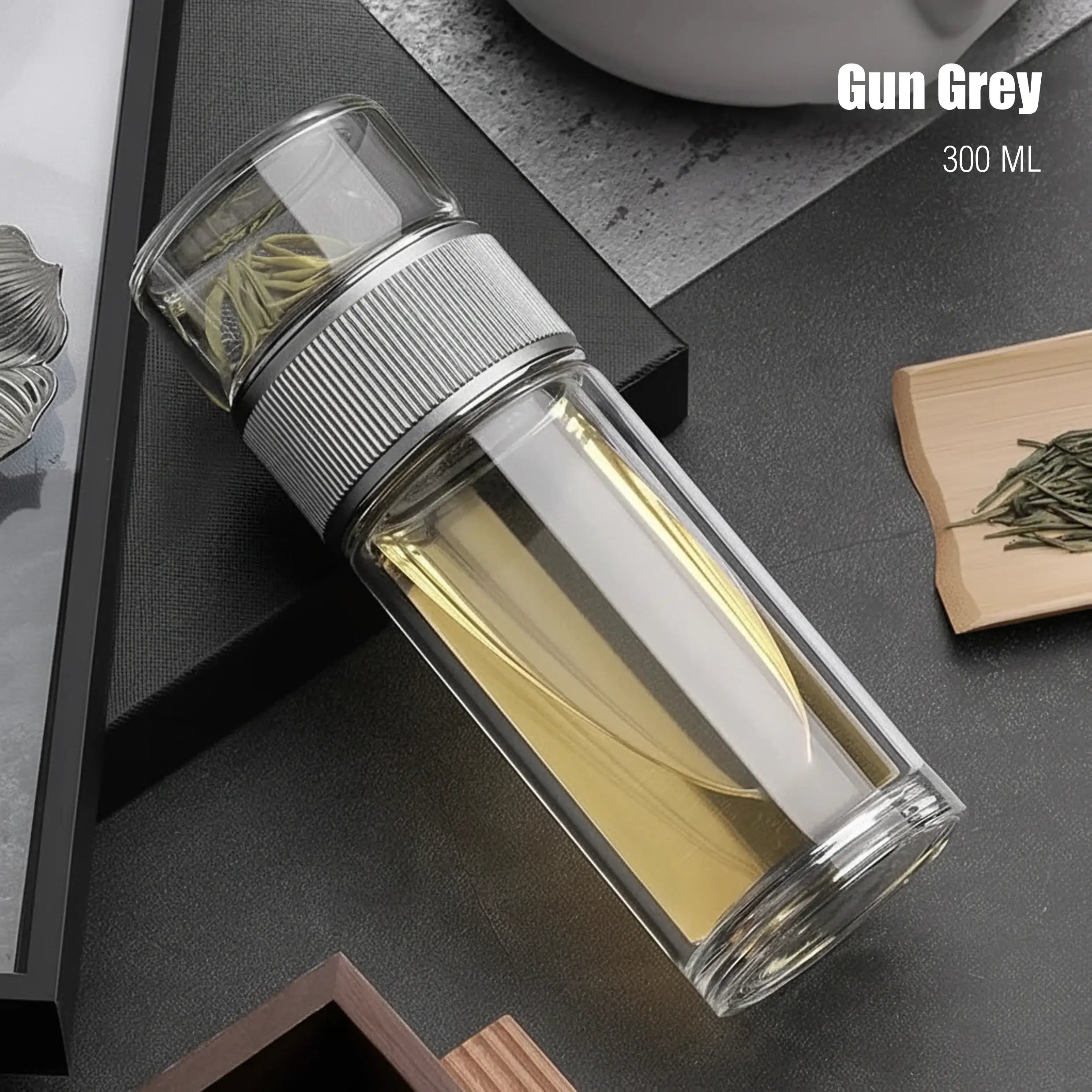 Clear glass bottle with metal cap on a dark surface