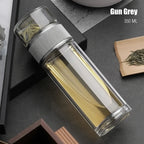 Clear glass bottle with silver lid on a dark surface, labeled 'Gun Grey 350 ML'.