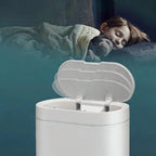 White trash bin with open lid on a dark background
