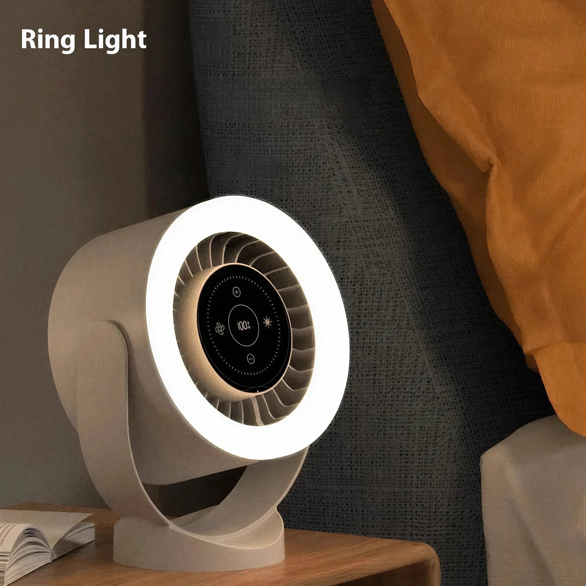 Ring light on a wooden surface with a dark curtain and orange blanket in the background