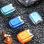 Four electric razor on a gravel surface with a car in the background.