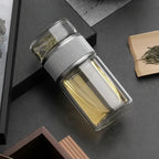 Clear glass container with silver lid on a dark surface